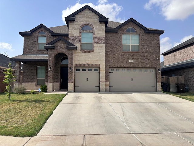 1815 Daybreak Way, Midland, TX 79705 - view of front of property featuring a front lawn, driveway, brick siding, and an attached garage