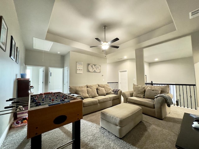 playroom with visible vents, attic access, ceiling fan, a tray ceiling, and carpet