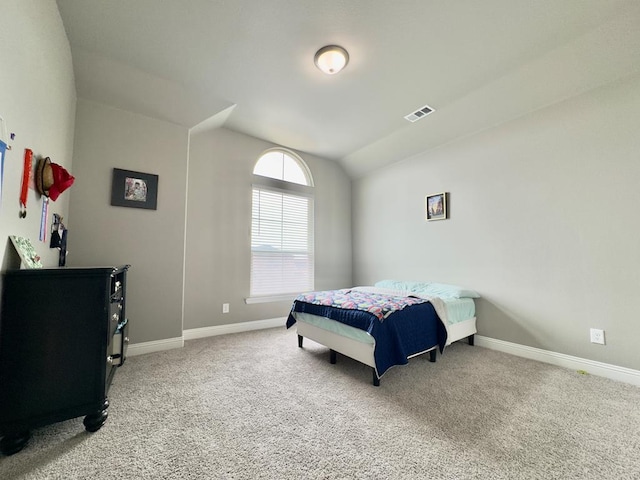 bedroom with baseboards, carpet, vaulted ceiling, and visible vents
