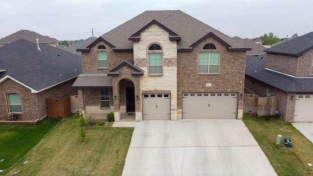1815 Daybreak Way, Midland, TX 79705 - french country home with driveway, brick siding, fence, a front yard, and roof with shingles