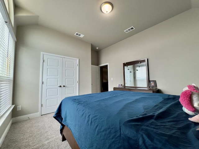 carpeted bedroom with multiple windows, vaulted ceiling, and visible vents