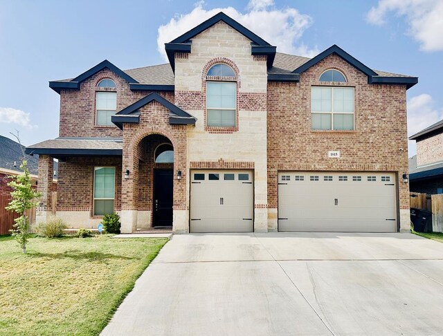 1815 Daybreak Way, Midland, TX 79705 - view of front of home with concrete driveway, brick siding, a garage, and a front lawn
