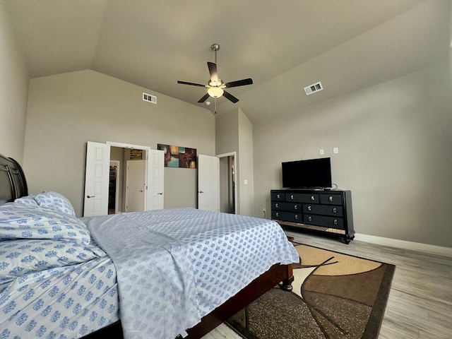 bedroom featuring visible vents, light wood-style floors, ceiling fan, and baseboards