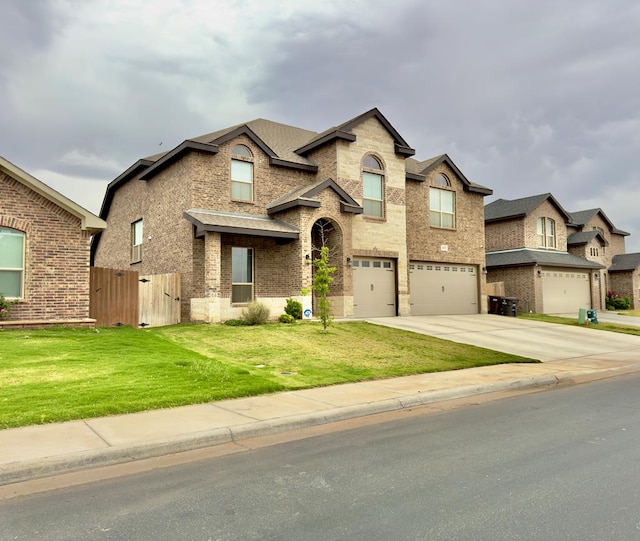 view of front of home with fence, an attached garage, brick siding, a front yard, and concrete driveway