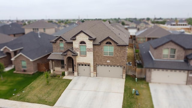 1815 Daybreak Way, Midland, TX 79705 - view of front of home with a garage, a residential view, concrete driveway, stone siding, and roof with shingles