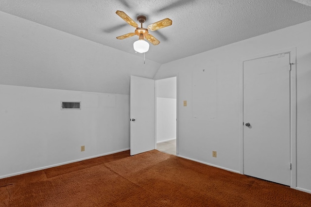 bonus room with lofted ceiling, carpet, and a textured ceiling