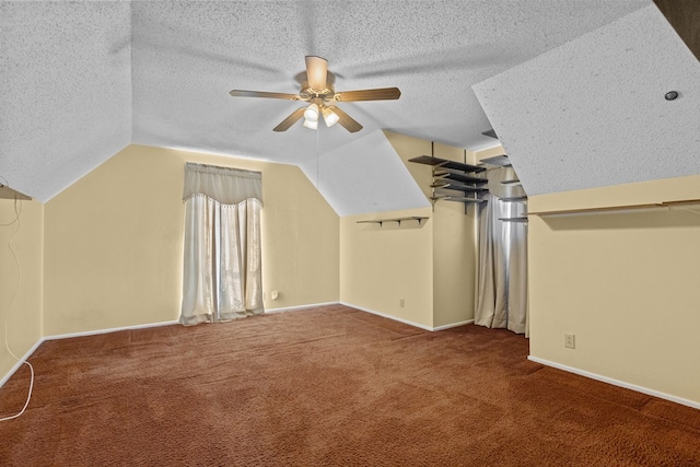 bonus room with vaulted ceiling, ceiling fan, carpet floors, and a textured ceiling