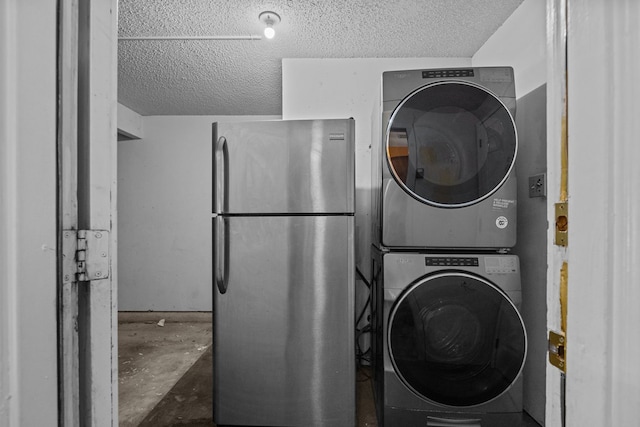 clothes washing area featuring stacked washer and dryer and a textured ceiling