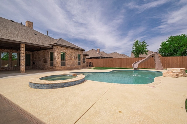 view of swimming pool with a water slide, a patio area, and a fenced backyard