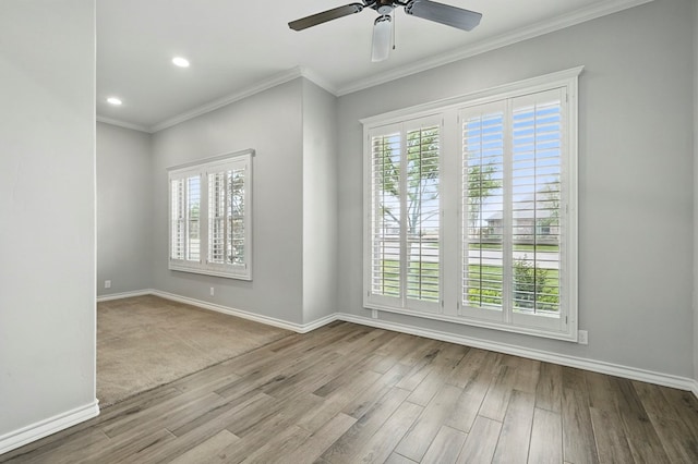 spare room featuring wood finished floors, baseboards, a ceiling fan, crown molding, and recessed lighting