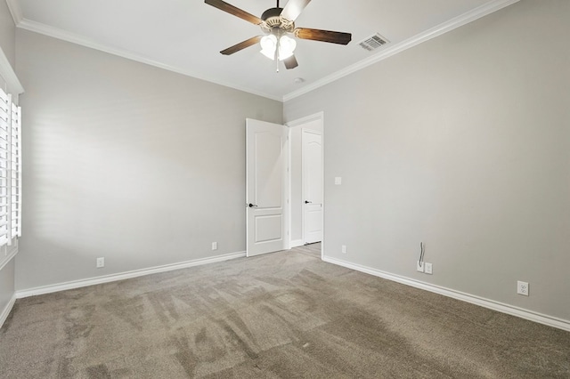 spare room featuring ceiling fan, ornamental molding, carpet floors, and baseboards