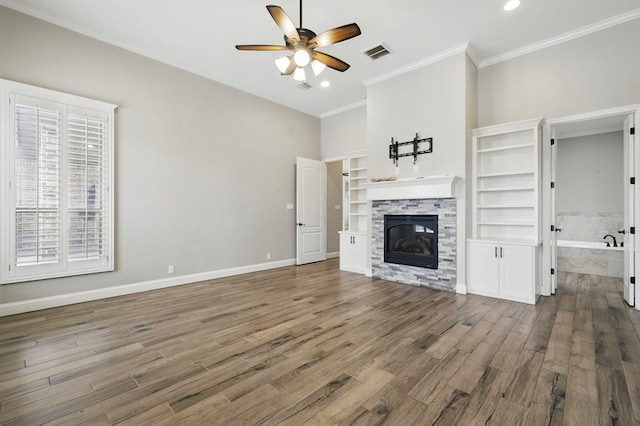 unfurnished living room with a ceiling fan, crown molding, a fireplace, wood finished floors, and recessed lighting
