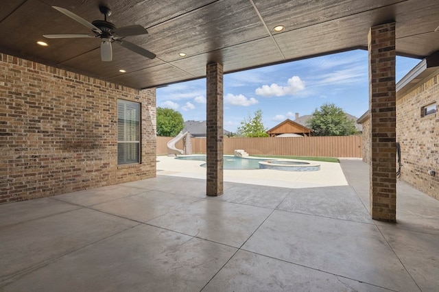 view of patio featuring a ceiling fan, a fenced backyard, and a pool with connected hot tub