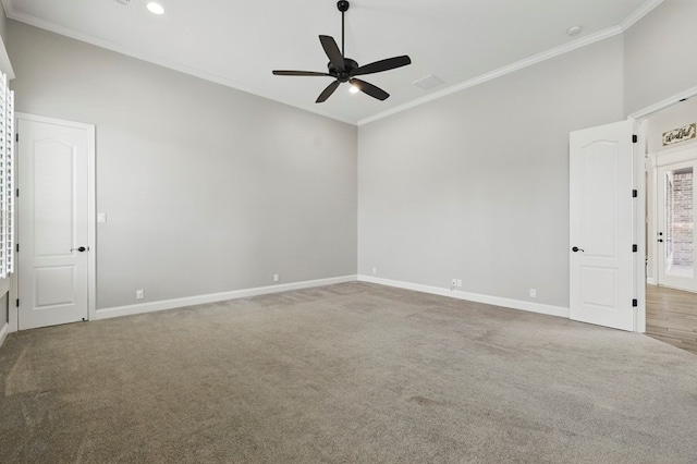 empty room with carpet, a ceiling fan, crown molding, and baseboards