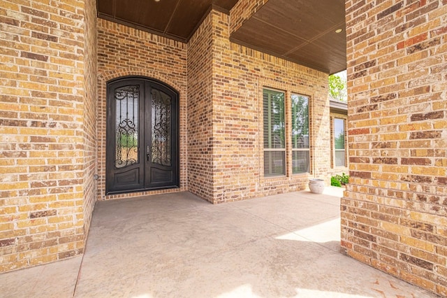 entrance to property featuring brick siding