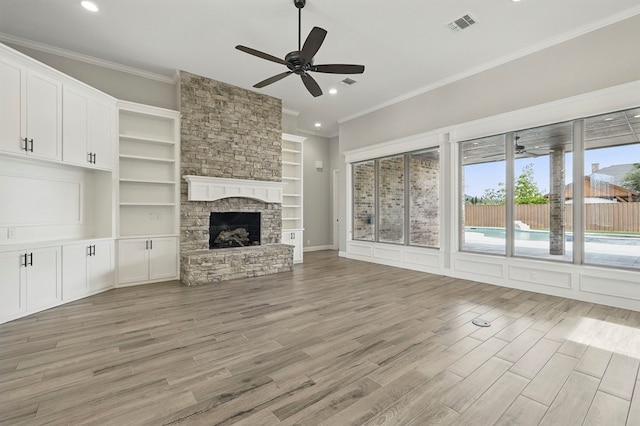 unfurnished living room featuring ceiling fan, crown molding, light wood-type flooring, recessed lighting, and a fireplace