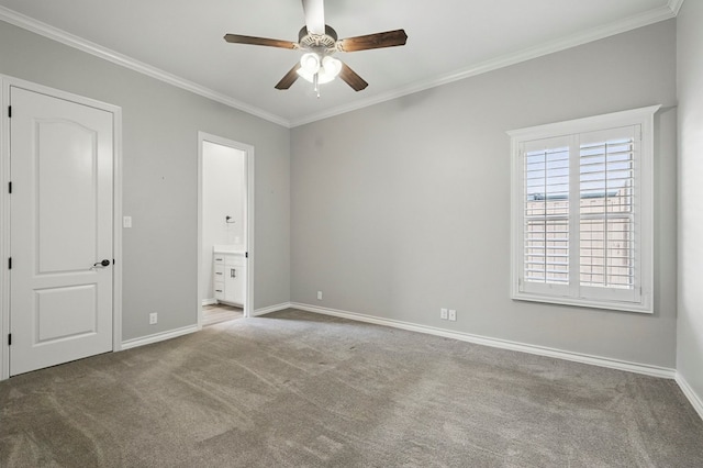 unfurnished bedroom featuring carpet, ornamental molding, baseboards, connected bathroom, and ceiling fan