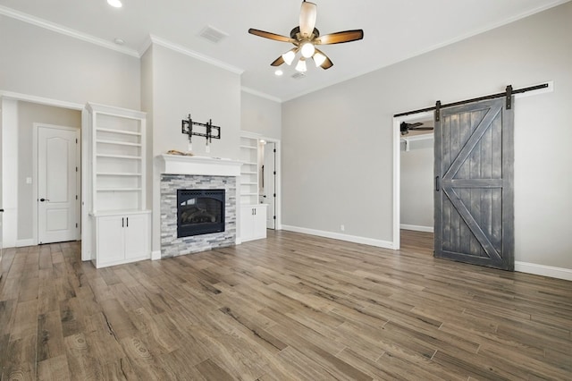 unfurnished living room featuring ceiling fan, a stone fireplace, baseboards, wood finished floors, and recessed lighting