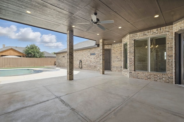 view of patio with a pool with connected hot tub, a fenced backyard, and ceiling fan