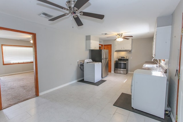 2004 State St, Big Spring, TX 79720 - kitchen with appliances with stainless steel finishes, washer / dryer, and a ceiling fan