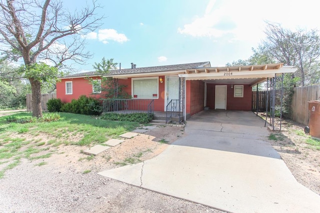 2004 State St, Big Spring, TX 79720 - single story home with concrete driveway and a carport