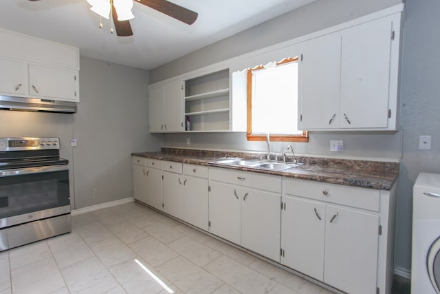 2004 State St, Big Spring, TX 79720 - kitchen featuring stainless steel electric range, under cabinet range hood, washer / clothes dryer, dark countertops, and a ceiling fan