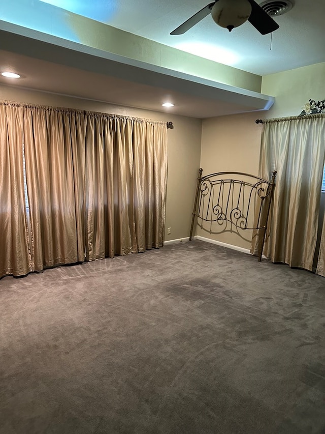 empty room with ceiling fan and carpet floors