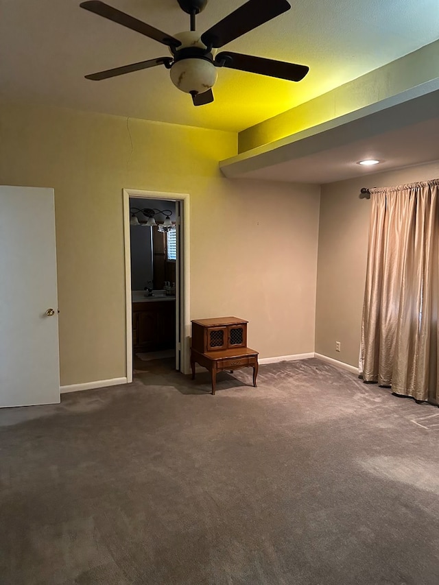 carpeted empty room featuring ceiling fan