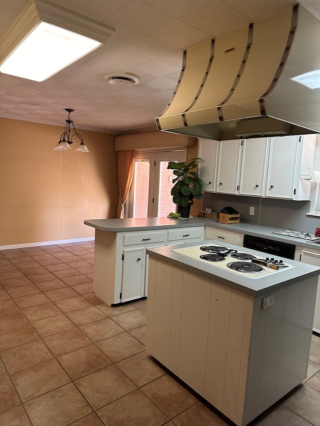 kitchen featuring exhaust hood, a center island, white cabinets, and pendant lighting