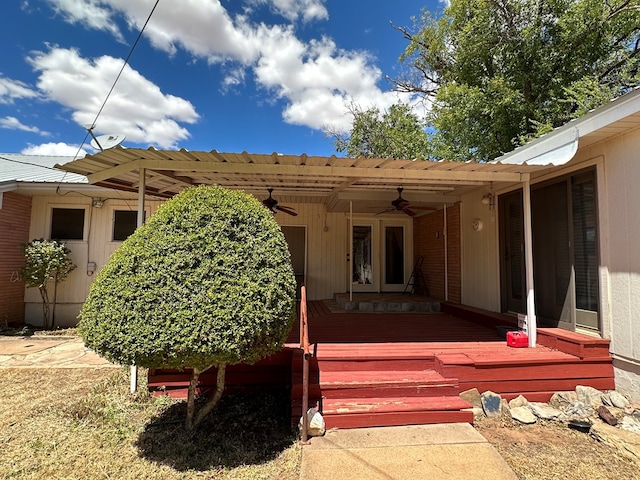 rear view of property with ceiling fan and a wooden deck