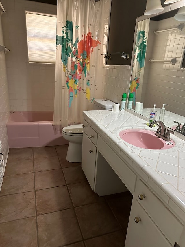 full bathroom featuring toilet, shower / tub combo, tile patterned floors, and tile walls