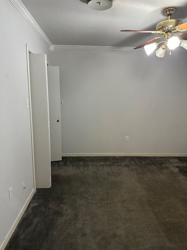 carpeted empty room with ceiling fan and crown molding