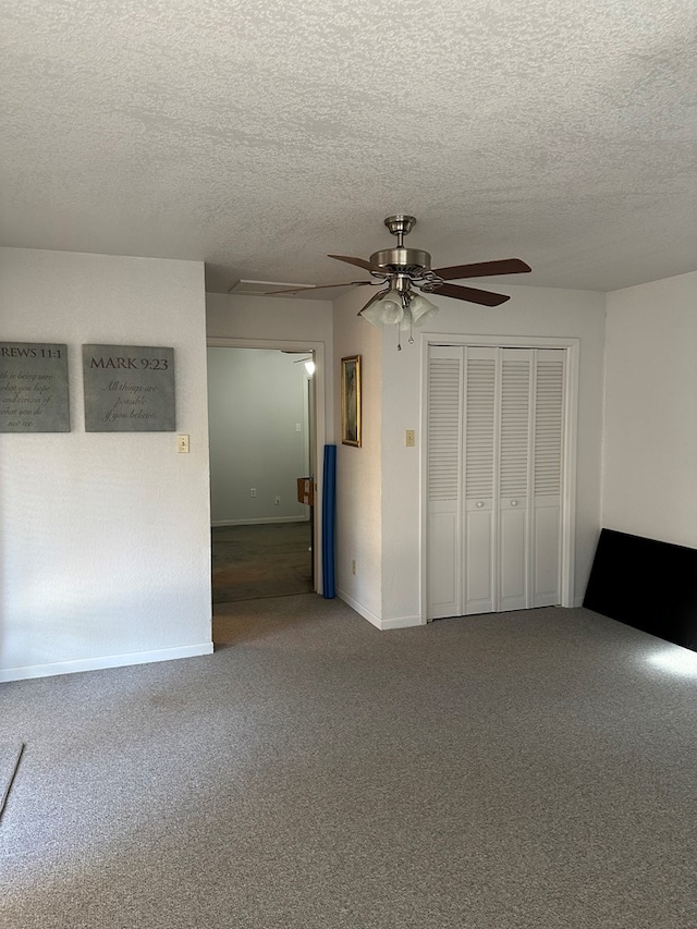 unfurnished bedroom featuring carpet flooring, ceiling fan, a closet, and a textured ceiling