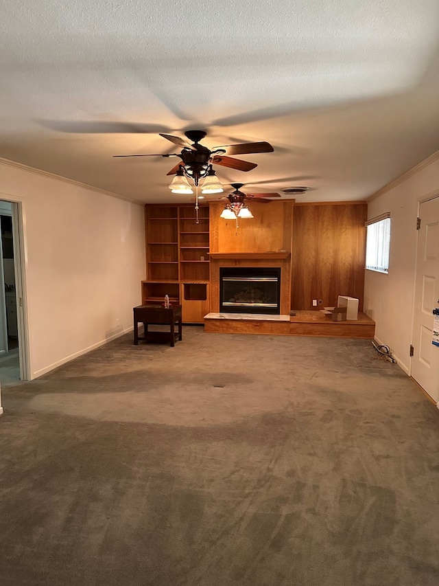 unfurnished living room featuring crown molding, a textured ceiling, and dark colored carpet