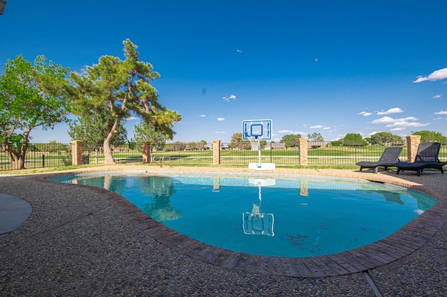 view of swimming pool featuring a fenced in pool and fence