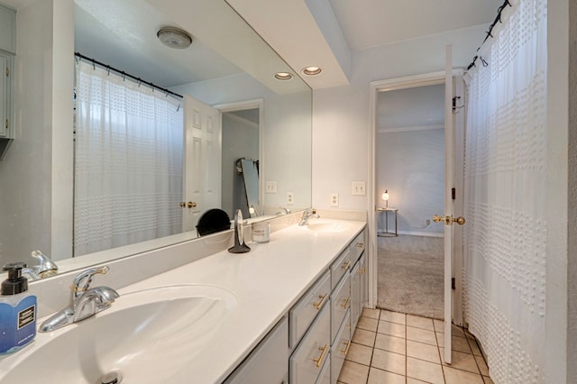 bathroom featuring a sink, double vanity, tile patterned flooring, and recessed lighting
