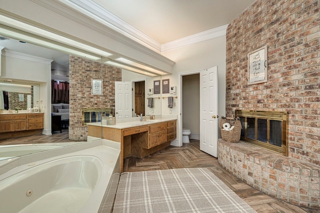 bathroom featuring toilet, a tub with jets, a fireplace, and ornamental molding