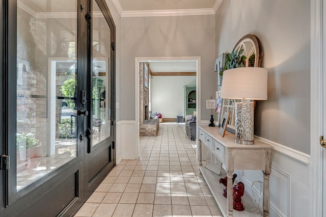 foyer entrance featuring ornamental molding, french doors, and light tile patterned floors