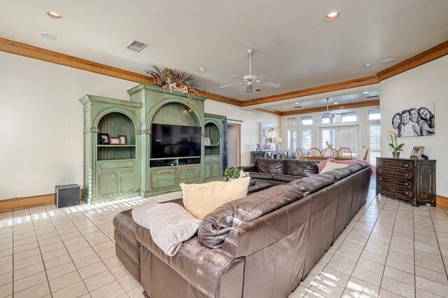 living room with crown molding, visible vents, a ceiling fan, and light tile patterned floors