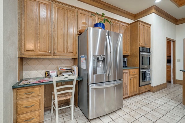 kitchen with ornamental molding, built in desk, appliances with stainless steel finishes, light tile patterned flooring, and backsplash