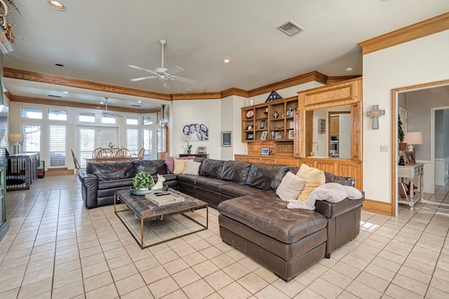 living area with visible vents, ceiling fan, crown molding, and light tile patterned flooring