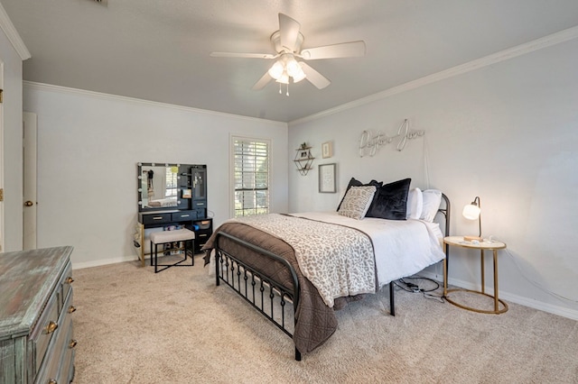 carpeted bedroom with crown molding, baseboards, and a ceiling fan