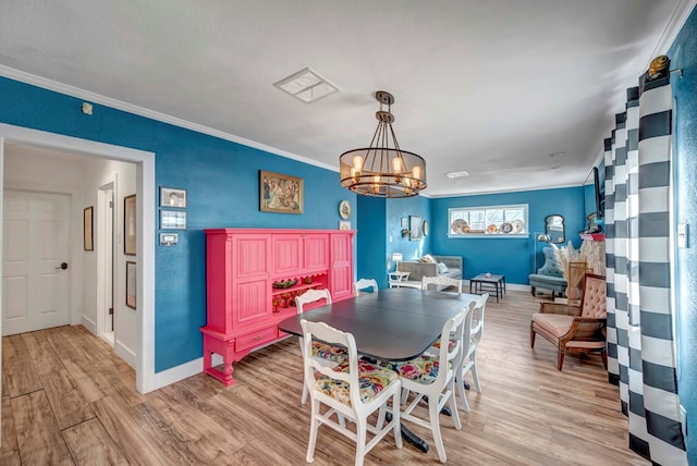 611 Storey Ave, Midland, TX 79703 - dining room featuring light wood-style flooring, a chandelier, crown molding, and baseboards