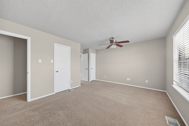 3237 Preston Dr, Midland, TX 79707 - unfurnished bedroom with a textured ceiling, carpet floors, and ceiling fan