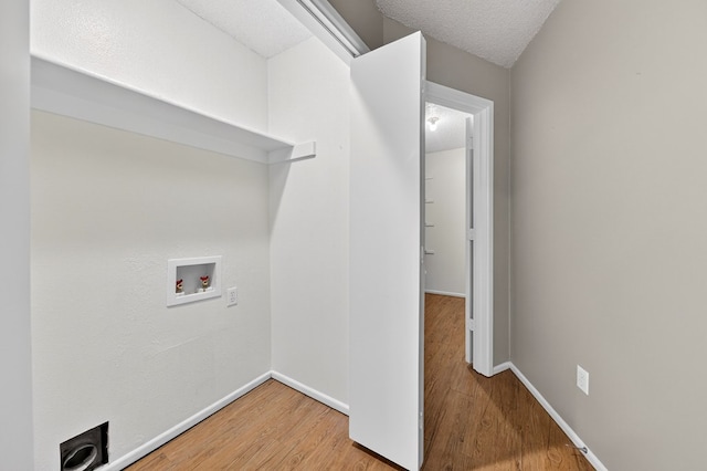 3237 Preston Dr, Midland, TX 79707 - laundry area with washer hookup and wood finished floors
