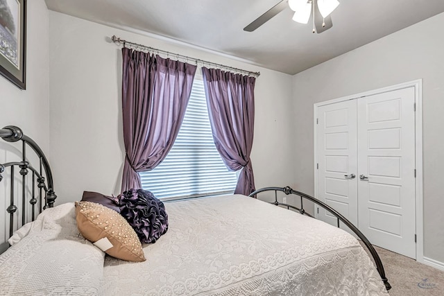 bedroom featuring a closet, carpet floors, baseboards, and ceiling fan