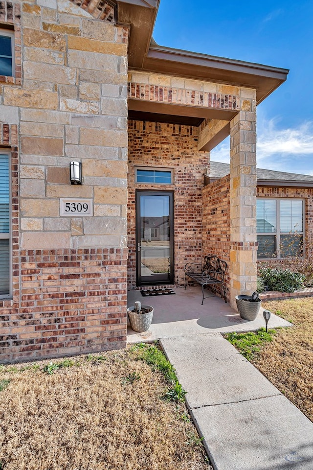 property entrance with brick siding