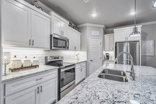 kitchen featuring a sink, stainless steel appliances, white cabinets, crown molding, and tasteful backsplash