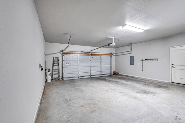 garage with electric panel, a garage door opener, and baseboards