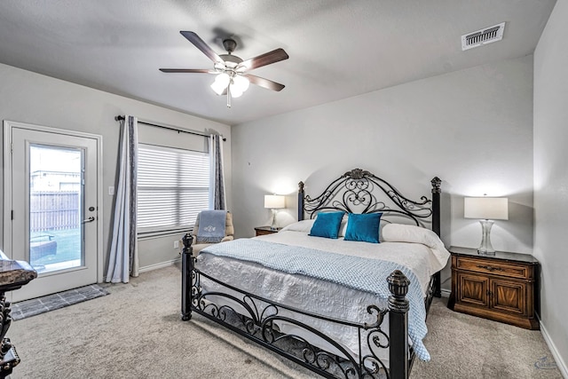 bedroom with light carpet, visible vents, a ceiling fan, and baseboards